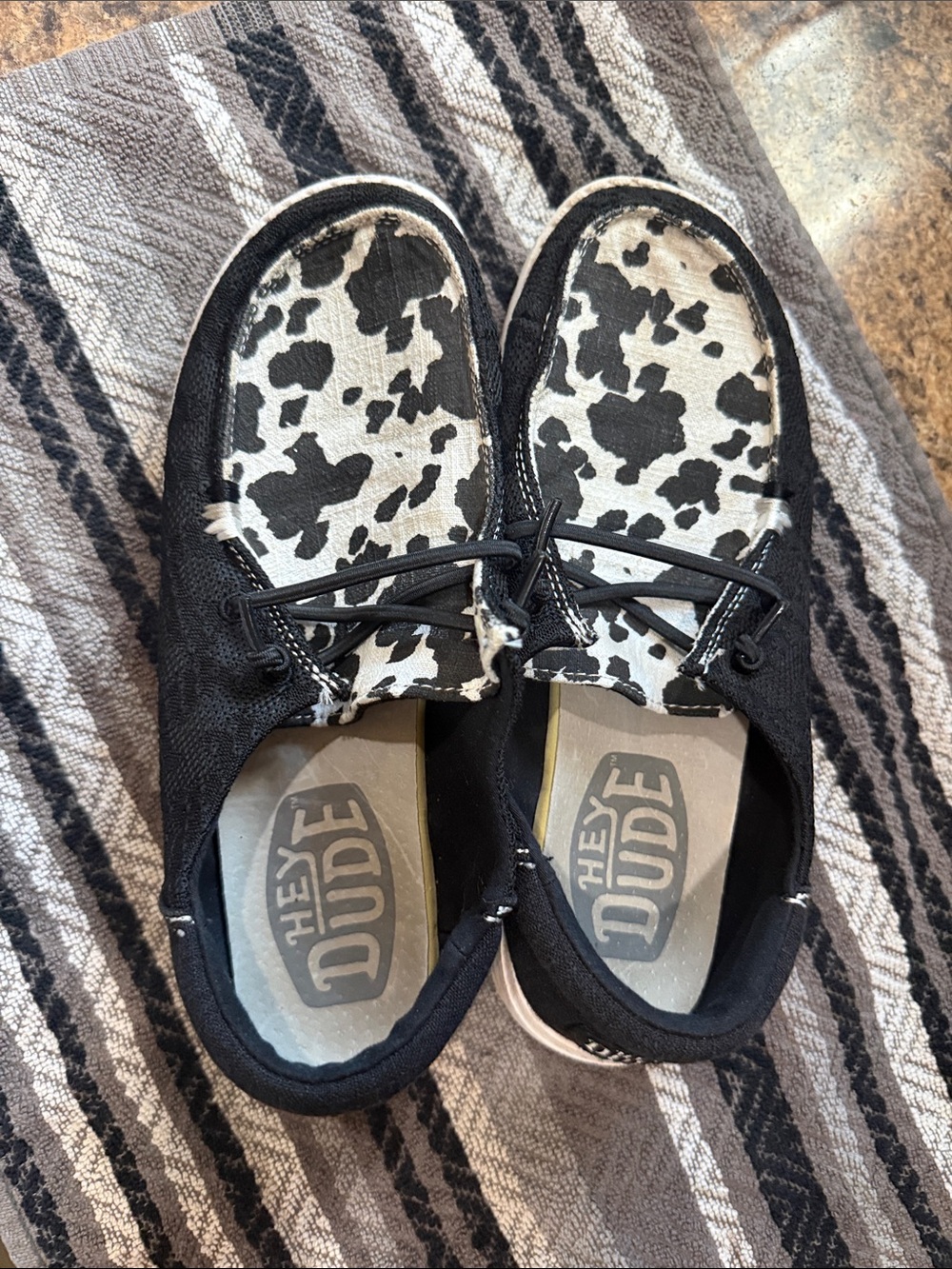 Hey Dudes woman’s Black and White Cow Print Slip-On Sneakers